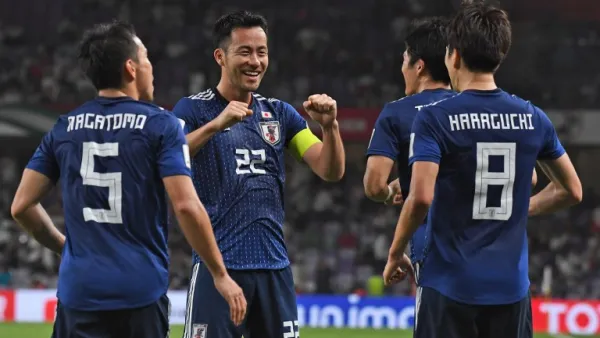 Japan's midfielder Genki Haraguchi (R) is congratulated for his goal during the 2019 AFC Asian Cup semi-final football match between Iran and Japan at the Hazza Bin Zayed Stadium in Abu Dhabi on January 28, 2019.
Roslan RAHMAN / AFP