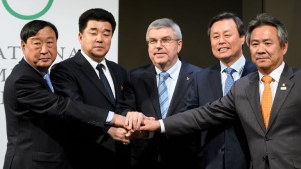 (From L) PyeongChang 2018 Olympics (POCOG) President Lee Hee-beom, North Korea's Sports Minister and Olympic Committee president Kim Il Guk, International Olympic Committee (IOC) President Thomas Bach, South Korean Minister of Culture, Sports and Tourism Do Jong-hwan and South Korea's National Olympic Committee President Lee Kee-heung join their hands as they pose during a signing ceremony at the Olympic Museum on January 20, 2018 in Lausanne. 
Fabrice COFFRINI / AFP