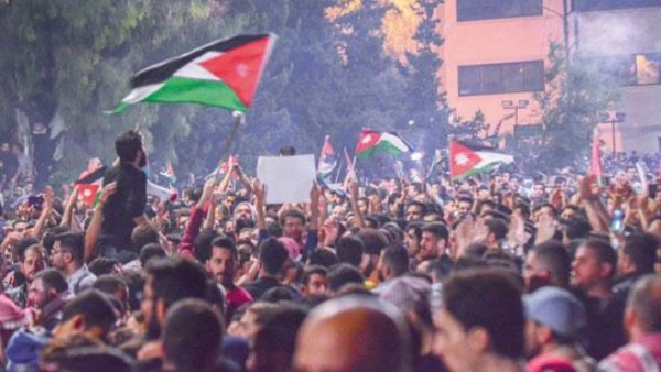 Protesters gather near the Fourth Circle in Amman calling for withdrawal of new income tax draft law from the Parliament on Tuesday. (Jordan Times)