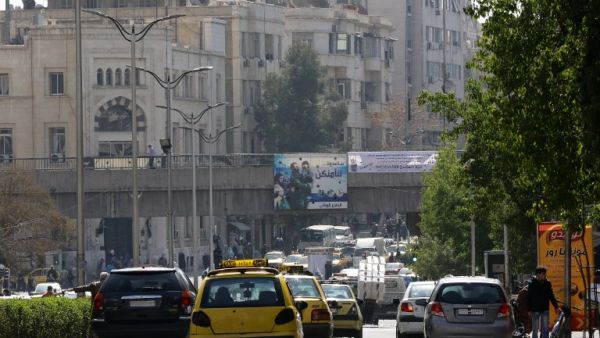 Syrian civilians go about daily life in Damascus on the first day of the ceasefire, February 27. (AFP/Louai Beshara)