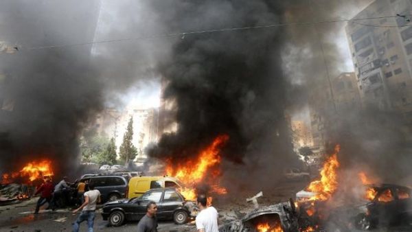 Civilians gather at the of an explosion in Beirut's southern suburb neighbourhood of Bir al-Abed on July 9 (AFP)
