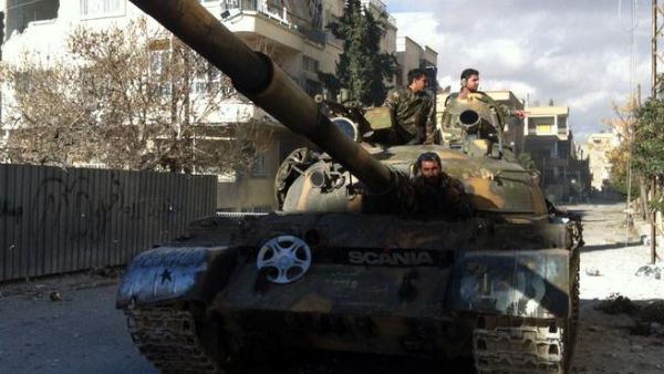 Syrian pro-government forces patrol in their tank in the town of Nabak near Damascus on December 7, 2013. [AFP]