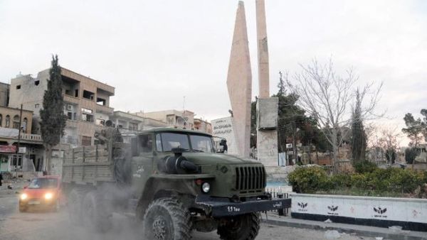 Syrian pro-government forces drive inside a military vehicle after capturing the town of Nabak, north of Damascus, near the border with Lebanon in the Qalamoun region, on December 9, 2013. [AFP]