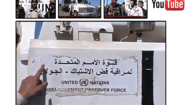  An image grab taken from a video uploaded on YouTube on Wednesday, allegedly shows armed fighters standing in front of a United Nations Disengagement Force (UNDOF) vehicle in the Golan Heights between Syria and Israel. (Image courtesy of AFP / YouTube)