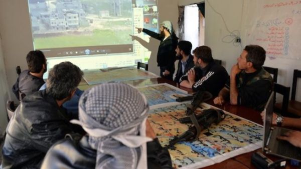 Fighters from the rebel al-Ezz bin Abdul Salam Brigade take part in a briefing at the brigade's base at an undisclosed location near the al-Turkman mountains, in Syria's northern Latakia province earlier this week. AFP Photo