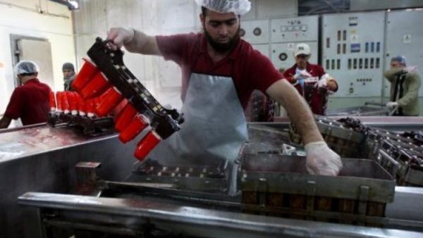Workers make ice cream at a factor in Khan Younis, a city in the Gaza Strip. (AFP/Said Khatib)