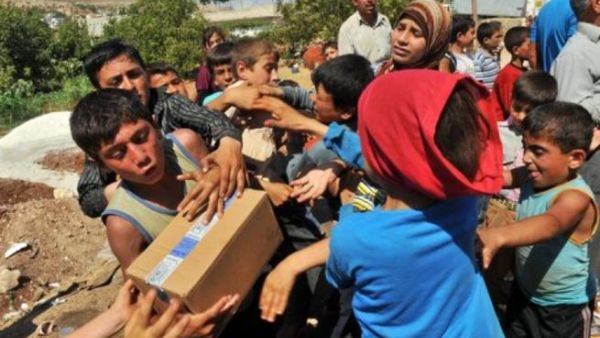 اطفال سوريون يتلقون مساعدات غذائية/أ.ف.ب