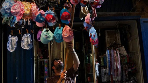 A man closes-up his shop in a market in Tripoli, Lebanon's second largest city, has suffered from the spillover of Syria's two-year-old war. Currently the Lebanese government officially hosts 546,000 Syrians with an estimated additional 500,000 who have not registered with the United Nations. . (Photo by Spencer Platt/Getty Images)