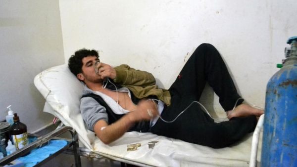 A man in Sarmin, a village outside Idlib, breathes through an oxygen mask after an alleged government gas attack in the area in March 2015.  (AFP/Mohamad Zeen)