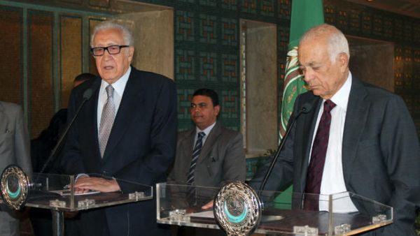 Arab League general secretary Nabil al-Arabi (R) listens to UN-Arab League envoy to Syria Lakhdar Brahimi speaking during a press conference following their meeting on October 20, 2013. (Image credit: AFP)