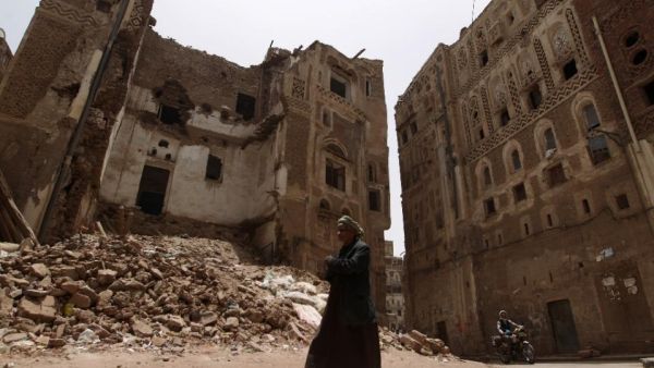 A man walks past a destroyed home in Old Sanaa, a UNESCO World Heritage site boasting mosques and homes dating from before the 11th century.  (AFP/Mohammed Huwais)