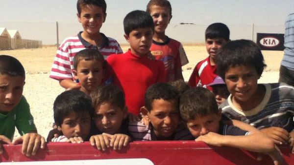 Syran refugee children at Zaatari camp awaiting their turn to play football at a workshop organized by Brazilian  coaches (Al Bawaba) 