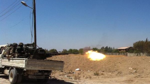 Syrian troops fire a heavy machine gun mounted on a pick-up truck in the Eastern Ghouta area on the northeastern outskirts of Damascus on August 30, 2013. TOPSHOTS/AFP PHOTO/SAM SKAINE