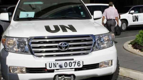 United Nations vehicles are seen leaving the hotel in Damascus on October 3, 2013. (Image credit: AFP)