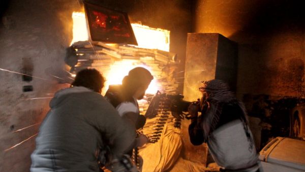Rebel fighters from the Free Syrian Army fire a heavy machine gun during fighting against government forces on November 18, 2013 in the Salah al-Din neighbourhood of the northern Syrian city of Aleppo. (Getty Images)