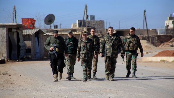 Syrian government forces walk in the village of Tal Jabin, north of Aleppo, as they advanced to break a three-year rebel siege and take control of parts of the supply route on February 3, 2016. (AFP/George Ourfalian)