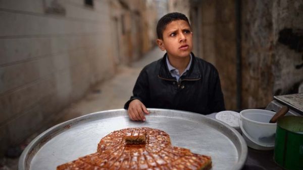 Similar to Omar, this Syrian boy is selling sweets on the streets of Aleppo. (AFP/File)