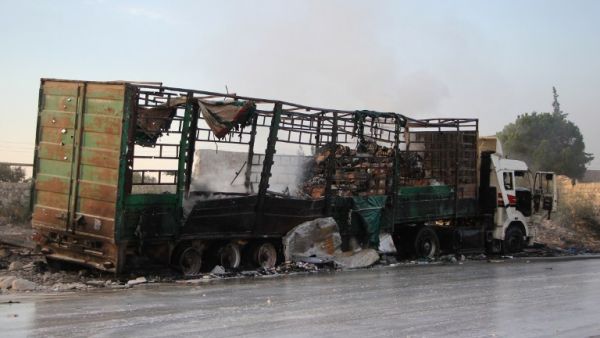 A damaged truck carrying aid is seen on the side of the road in the town of Orum al-Kubra on the western outskirts of the northern Syrian city of Aleppo on September 20, 2016, the morning after a convoy delivering aid was hit by a deadly air strike. (AFP/Omar Haj Kadour)