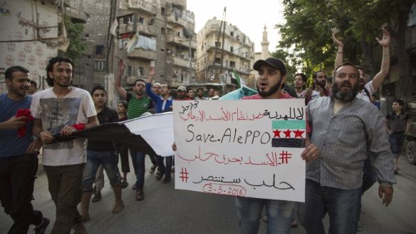Syrians shout slogans during an anti-regime protest in the rebel-held Bustan al-Qasr district in eastern Aleppo on May 5, 2016. (AFP/Karam al-Masri)