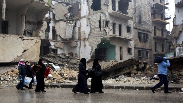 Syrians leave a rebel-held area of Aleppo towards the government-held side on December 13, 2016 during an operation by Syrian government forces to retake the embattled city. (AFP/Karam al-Masri)