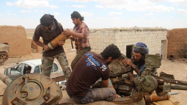 Rebel fighters from the Jaish al-Fatah (or Army of Conquest) brigades load ammunitions into a tank during clashes with Syrian pro-government forces near the village of Om al-Krameel, in Aleppo's southern countryside on May 5, 2016. (AFP/Omar Haj Kadour)