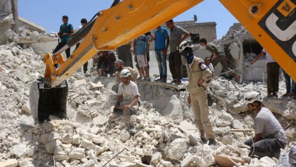 Syrian civil defense workers look for survivors under the rubble of a collapsed building following reported air strikes on July 17, 2016 in the rebel-controlled neighborhood of Karm Homad in the northern city of Aleppo. (AFP/Thaer Mohammed)