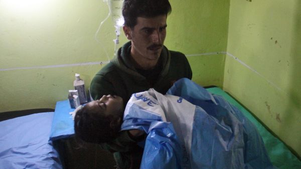 An unconscious Syrian child is carried at a hospital in Khan Sheikhun, a rebel-held town in the northwestern Syrian Idlib province, following a suspected toxic gas attack on April 4, 2017. (AFP/Omar Haj Kadour)