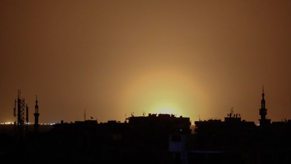 Flames rise into the night sky from a Damascus airport believed to have been hit by an Israeli airstrike, April 27 2017. (AFP/Sameer Al-Doumy)