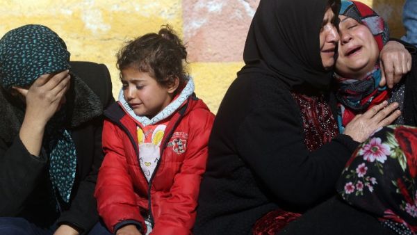 Relatives of a Kurdish herder mourn outside the hospital in Afrin on January 28, 2018, after he was killed in a Turkish airstrike on their village near the Kurdish enclave (Delil Souleiman/AFP)