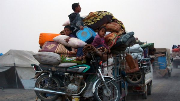 Displaced Syrians, who fled the countryside surrounding the Islamic State (IS) group stronghold of Raqqa, arriving at a temporary camp in the village of Ain Issa (AFP)
