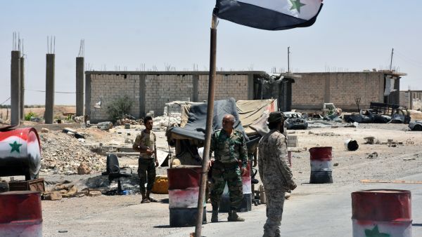 Members of the Syrian pro-government forces holding a security checkpoint in the village of Khirbat al-Sa'ab, on the western outskirts of Raqa province. (AFP)