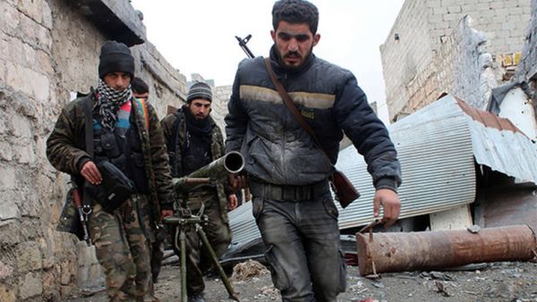 Opposition fighters carrying a rocket launcher during clashes against government forces in the Sheikh Lutfi area, west of the airport in the northern Syrian city of Aleppo (AFP)