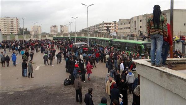 Militants and their families gather as they prepare to board a bus ahead of their evacuation from the al-Waer neighborhood of the Syrian city of Homs, March 18, 2017. (AFP/File)