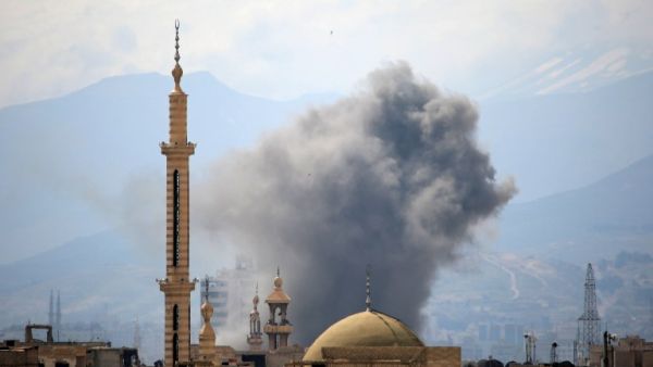 Smoke billows following a reported air strike in the rebel-held parts of the Jobar district, on the eastern outskirts of the Syrian capital Damascus, on March 20, 2017. (AFP/Amer Almohibany)
