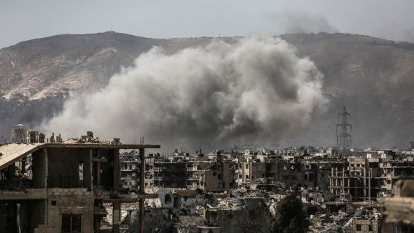 Smoke billows following a reported air strike in the rebel-held parts of the Jobar district, on the eastern outskirts of the Syrian capital Damascus, on March 19, 2017. (AFP/Amer Mohibany)
