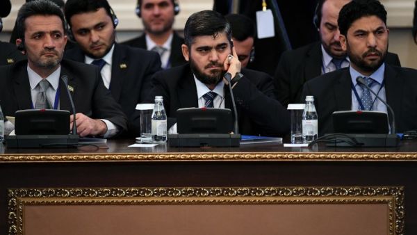 This file photo taken on January 23, 2017 shows chief opposition negotiator Mohammad Alloush (C) of the Jaish al-Islam (Army of Islam) rebel group attending the first session of Syria peace talks at Astana's Rixos President Hotel. (AFP/Kirill Kudryavtsev)