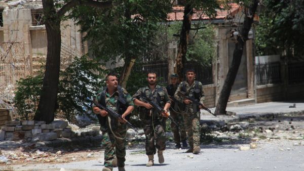 Syrian army soldiers patrol a damaged area of west Aleppo (AFP/File)