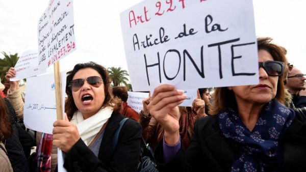 Tunisian women protest an article of the country's penal code that allowed rapists to marry their victims (AFP)
