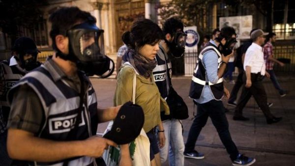 Turkish policeman detain a protestor during a protest on Istiklal Avenue in Istanbul on July 8 (AFP)