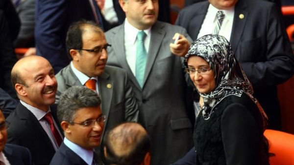 Turkey's ruling Justice and Development Party (AKP) MP Gulay Samanci (R) is greeted as she attends a general assembly meeting wearing a headscarf at the Turkish Parliament in Ankara. (Image credit: AFP)