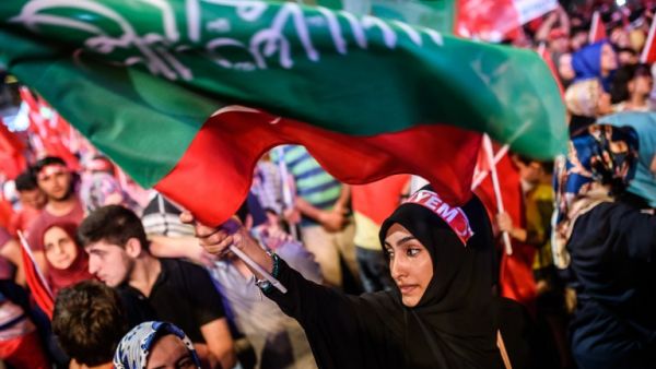A woman waves flags during a pro-Erdogan rally in Taksim square in Istanbul on July 22, 2016, following the failed military coup attempt of July 15. (AFP/Ozan Kose) A woman waves flags during a pro-Erdogan rally in Taksim square in Istanbul on July 22, 2016, following the failed military coup attempt of July 15. (AFP/Ozan Kose)
