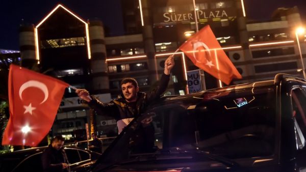 A man waves a Turkish national flag during a demonstration on December 11, 2016 a day after twin bombings near the home stadium of Besiktas football club. (AFP/Yasin Akgul)