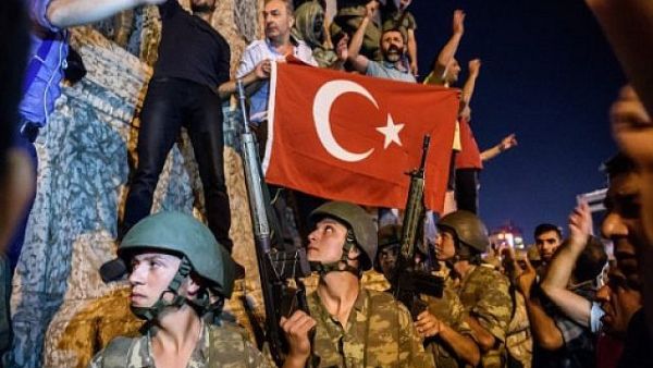 Turkish soldiers stand in Taksim Square in Istanbul as people protest against the military coup on July 16, 2016. (AFP Photo/Ozan Kose)