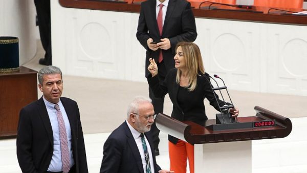 Turkish deputy Aylin Nazliaka (C) speaks with other deputies after handcuffing herself to the podium in a protest against the constitutional reform aimed at strengthening the powers of the Turkish president during a debate at the Turkish Parliament in Ankara on January 19, 2017. (AFP/Adem Altan)