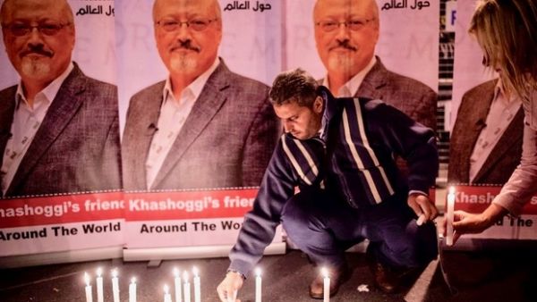 Man lights candles for Jamal Khashoggi outside the Saudi Arabia consulate in Istanbul (AFP/File)
