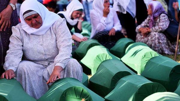 Bosnian Muslim women offers prayers near the caskets of 71 victims of the 1995 Srebrenica massacre. (AFP/ File)