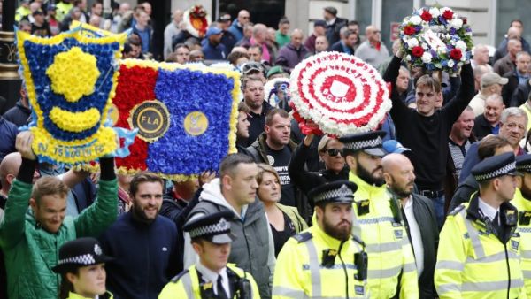 Thousands of football fans have gathered in London to protest extremism - alongside the founder of far-right racist organization the English Defence League (EDL) (AFP)