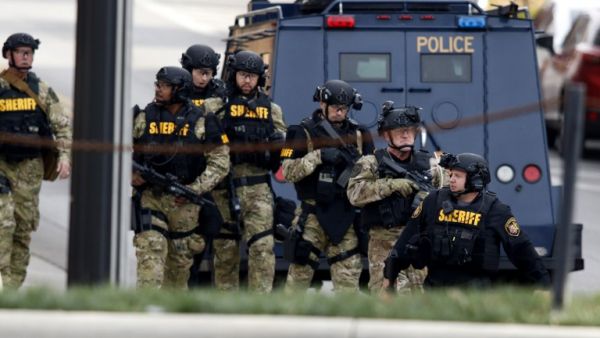Police attend the scene of the stabbing yesterday (Paul Vernon/AFP)