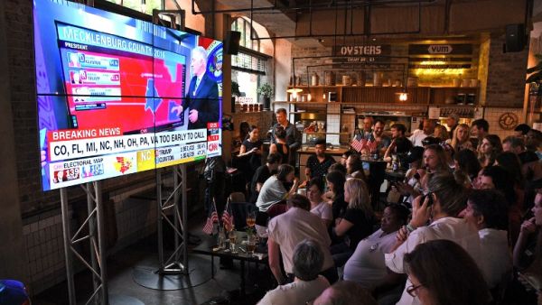 Should there be a Trump win, the sell-offs in global markets will be compounded by the markets having priced in a Clinton victory and were wrong. (AFP/William West)