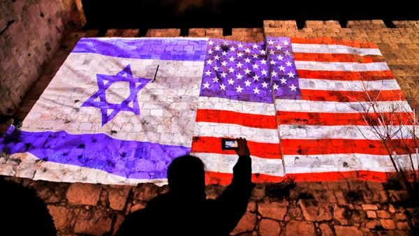 The American and Israeli flags projected onto Jerusalem's Old City Walls. Ahmad Gharabli/AFP